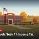 Fostoria News Fostoria school building with American flag and school bus in fall setting.